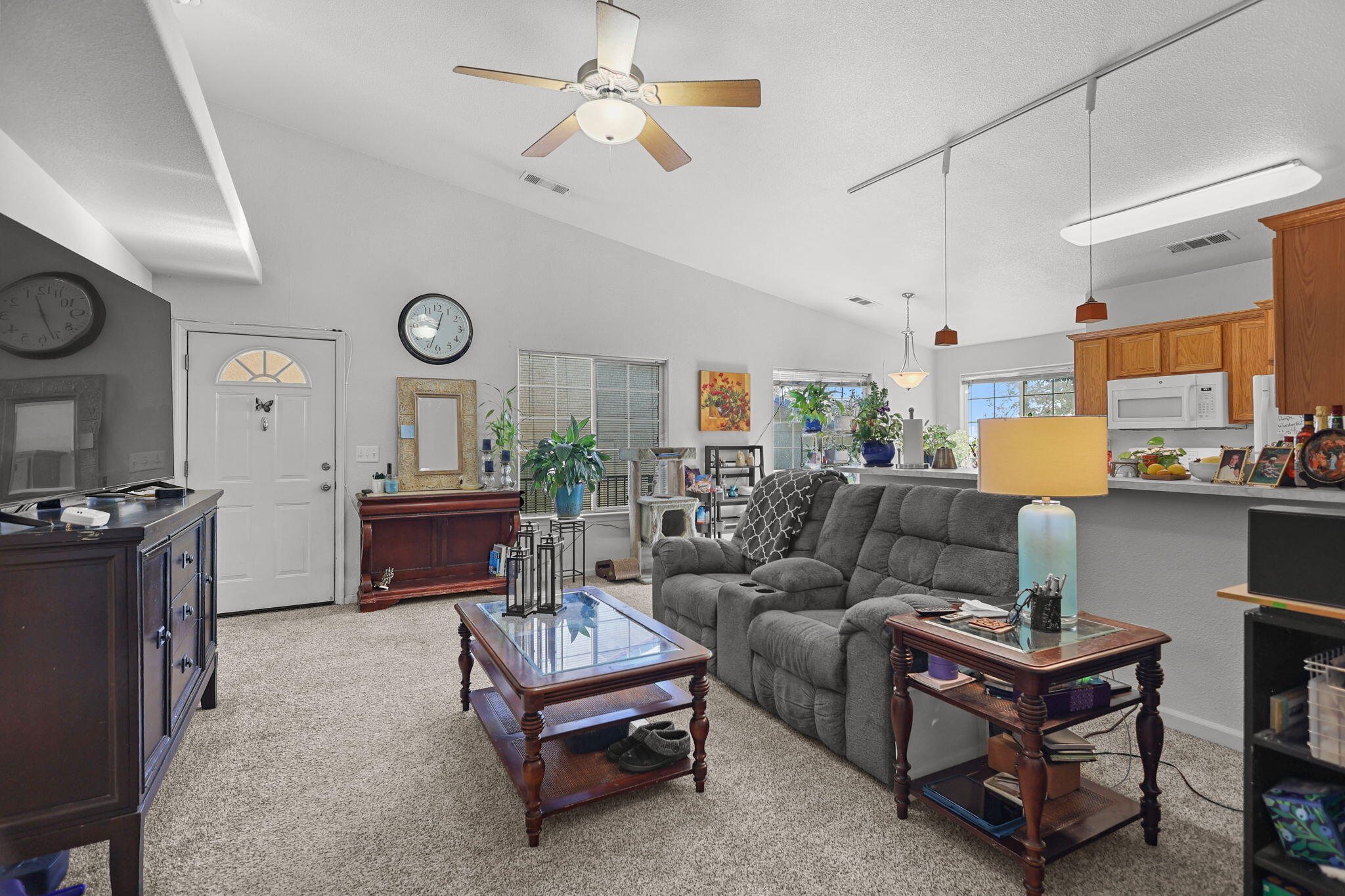 720 Stonebriar Trail Redding, CA 96003 - Photo 4 of 19 a living room with furniture kitchen view and a chandelier