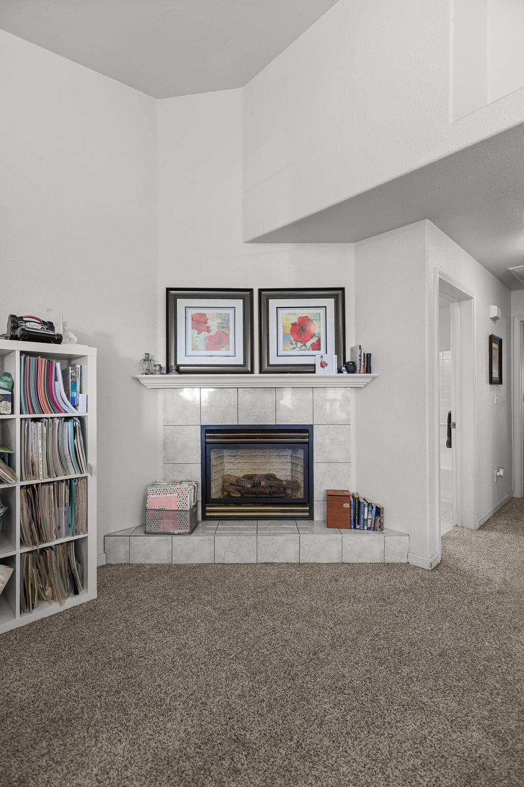 720 Stonebriar Trail Redding, CA 96003 - Photo 5 of 19 a living room with a fireplace and a book shelf