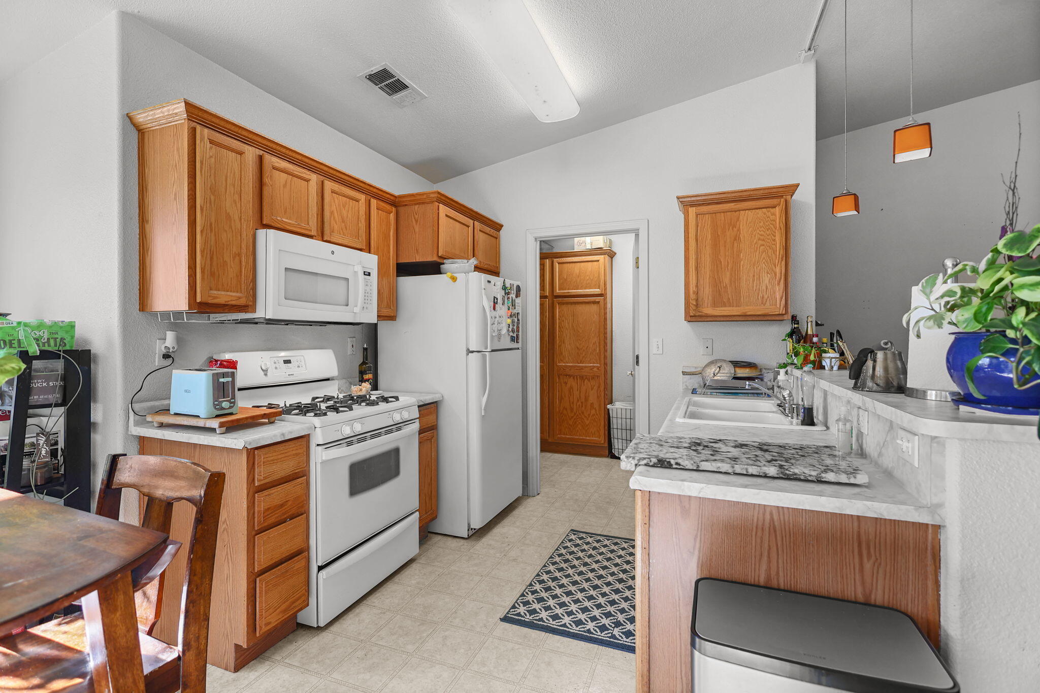720 Stonebriar Trail Redding, CA 96003 - Photo 7 of 19 a kitchen with a stove a sink and a refrigerator