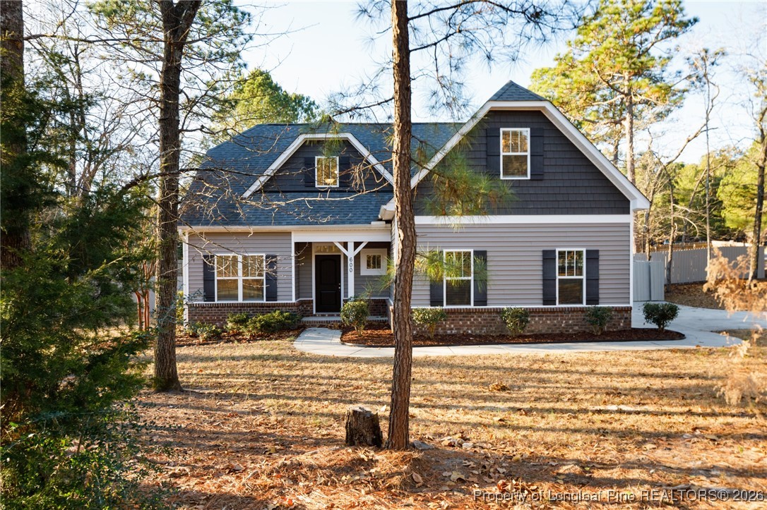 600 Burning Tree Road Pinehurst, NC 28374 - Photo 1 of 31 a front view of a house with a yard covered with snow