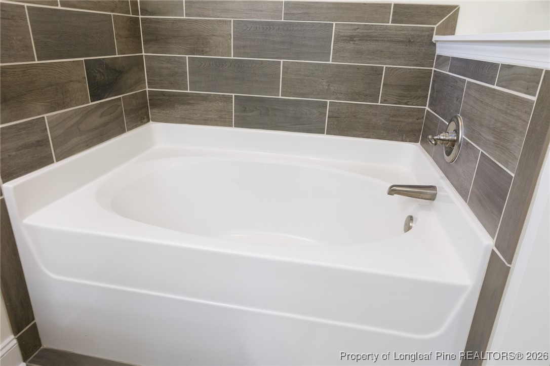 600 Burning Tree Road Pinehurst, NC 28374 - Photo 19 of 31 a white bath tub and a sink