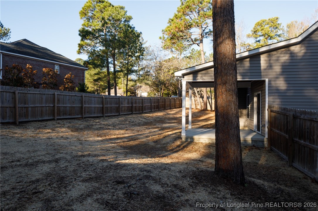 600 Burning Tree Road Pinehurst, NC 28374 - Photo 29 of 31 a view of backyard with wooden fence and large trees
