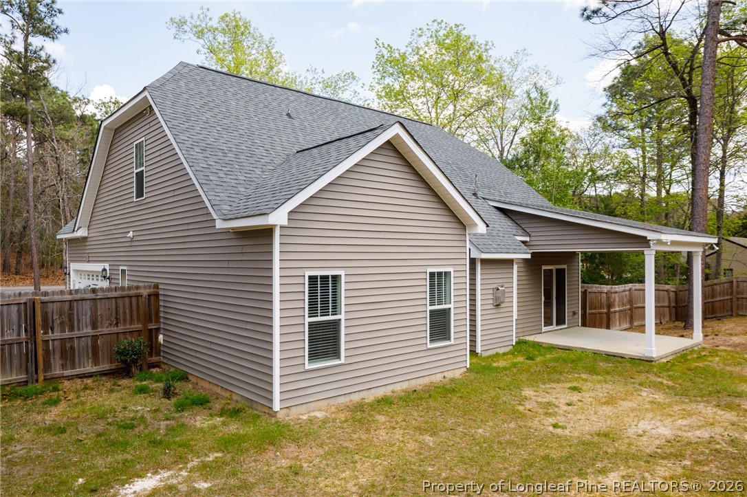 600 Burning Tree Road Pinehurst, NC 28374 - Photo 31 of 32 a view of backyard of house with wooden fence and large trees
