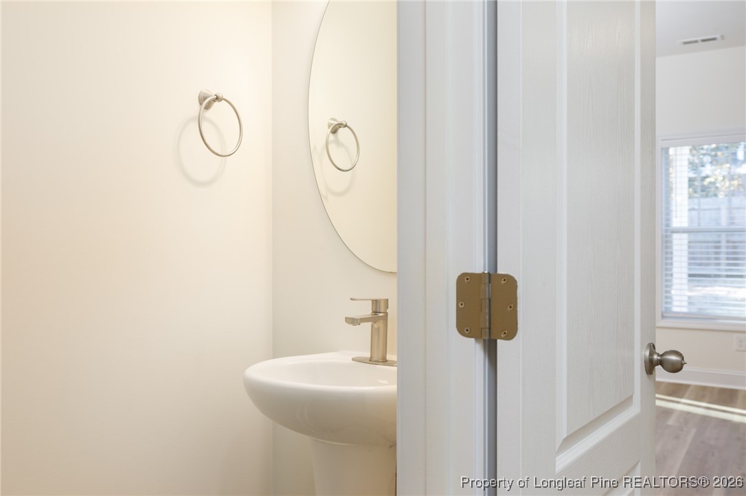 600 Burning Tree Road Pinehurst, NC 28374 - Photo 7 of 31 a bathroom with a sink and mirror