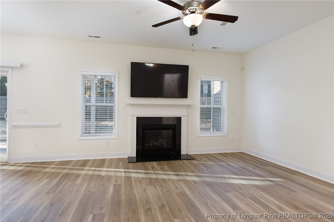 600 Burning Tree Road Pinehurst, NC 28374 - Photo 8 of 31 a view of an empty room with a fireplace and a window