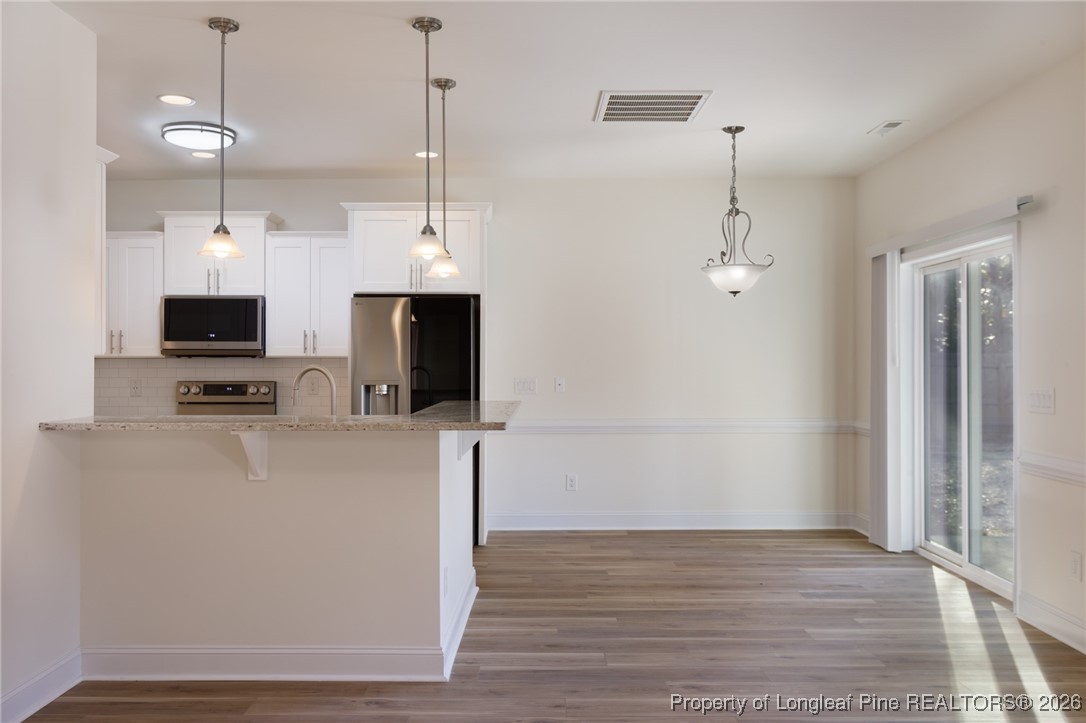 600 Burning Tree Road Pinehurst, NC 28374 - Photo 9 of 31 a view of a kitchen with microwave and cabinets