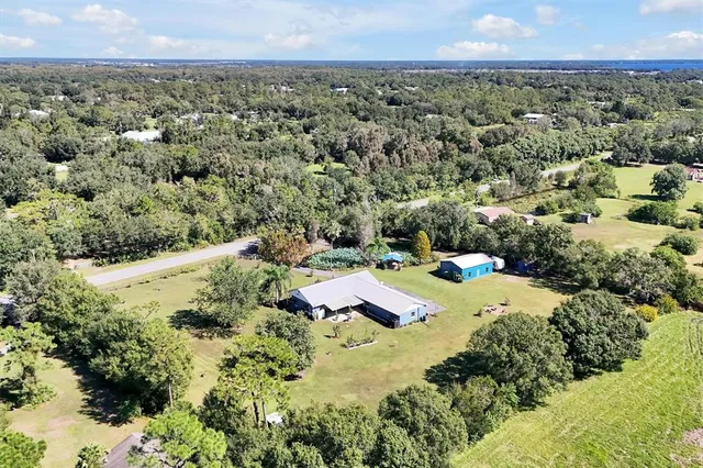 a backyard of a house with lots of green space and garden