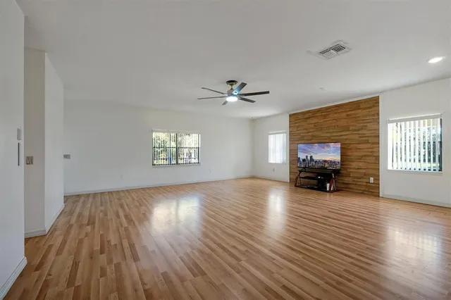 a large kitchen with stainless steel appliances cabinets a sink and a stove