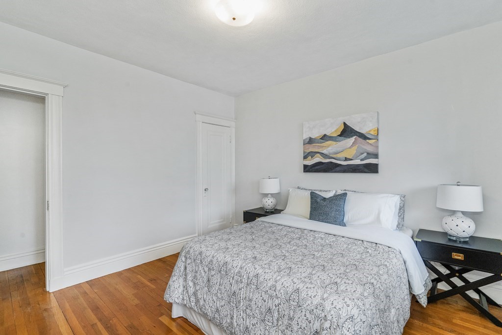 8 Kinross Road, Unit 4 Boston, MA 02135 - Photo 8 of 13 a bedroom with a bed and wooden floor