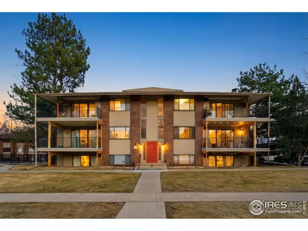 a view of an apartment with floor to ceiling windows and yard