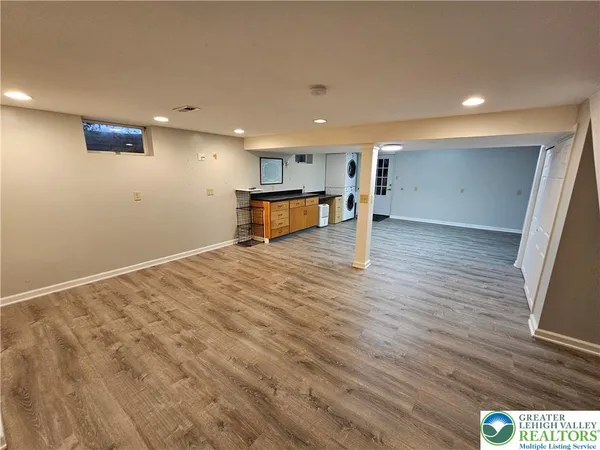 a view of a room with wooden floor and window