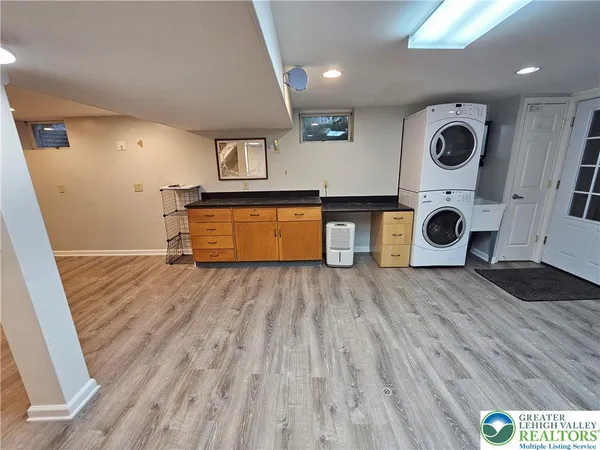 a view of a kitchen with a fridge and wooden floor