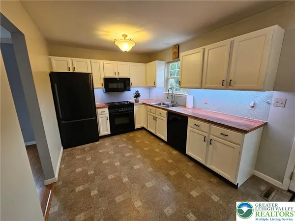 a kitchen with a refrigerator and a sink