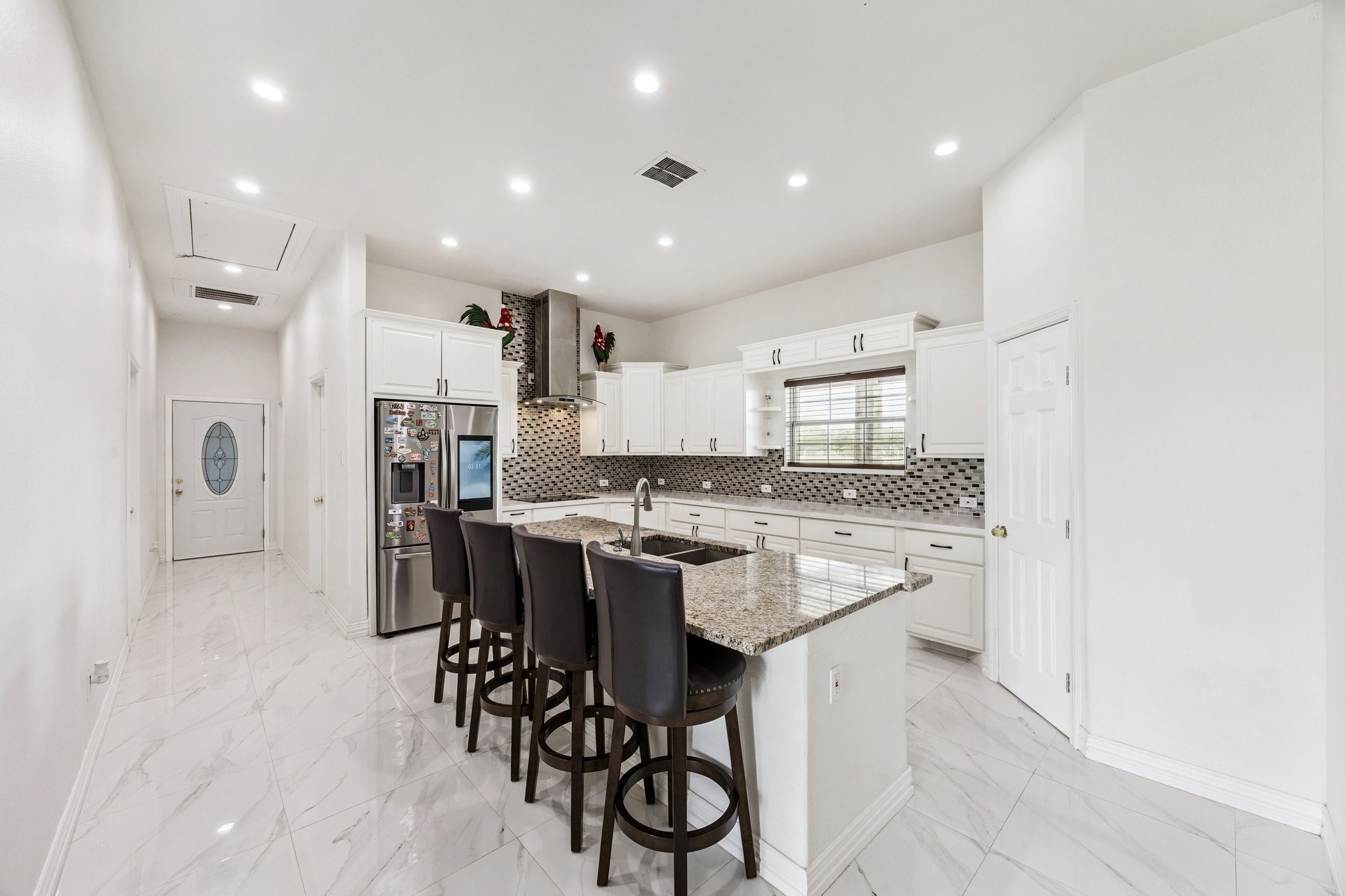 2787 Maler Road Sealy, TX 77474 - Photo 4 of 17 a kitchen with stainless steel appliances kitchen island granite countertop a table and chairs in it