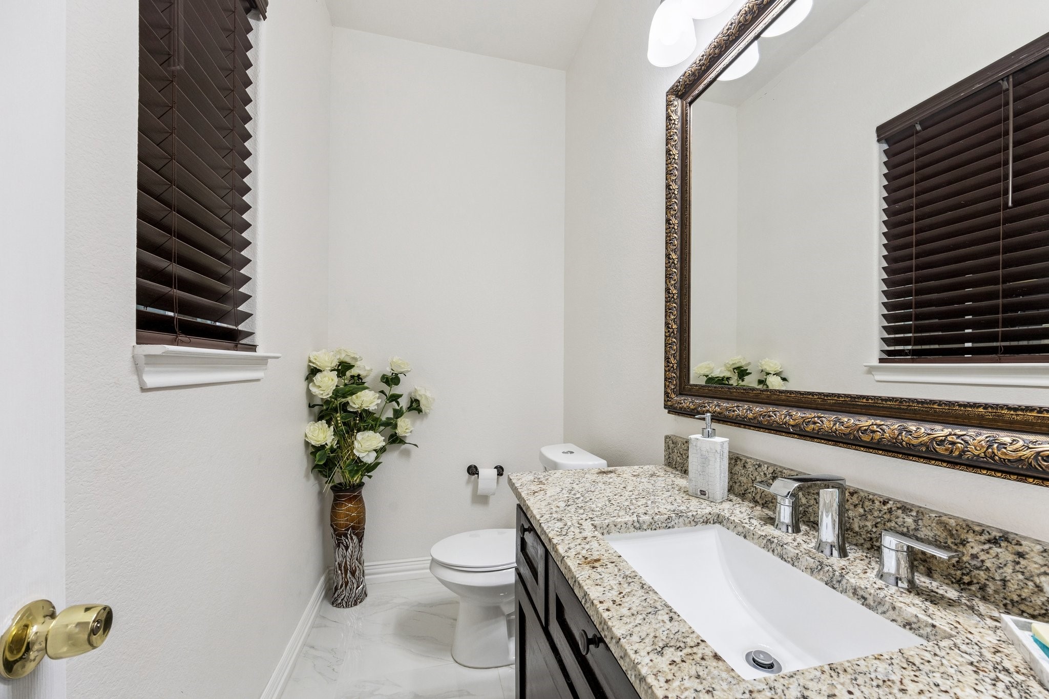 2787 Maler Road Sealy, TX 77474 - Photo 10 of 17 a bathroom with a granite countertop toilet a sink and a mirror