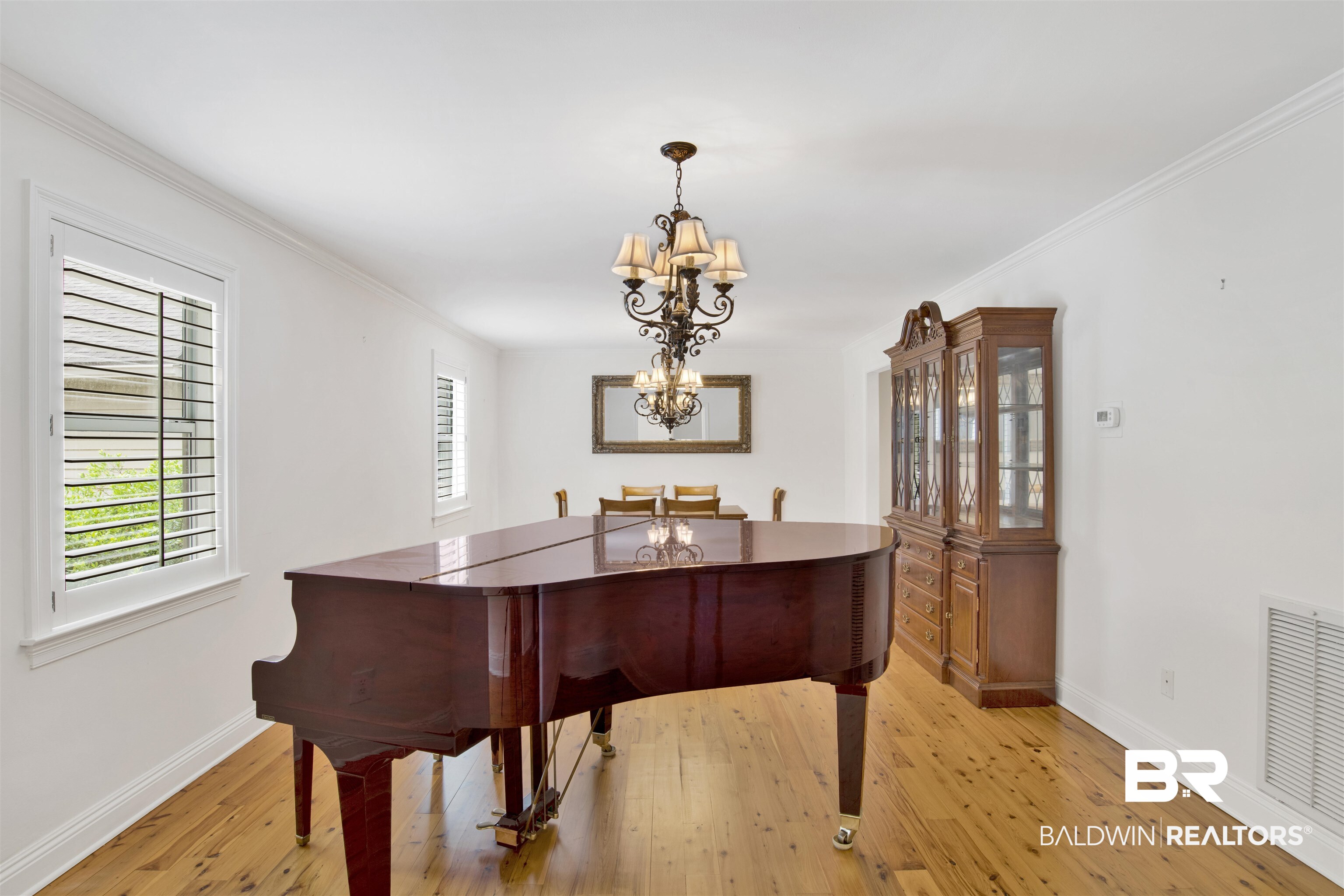 16864 Ferry Rd Circle Fairhope, AL 36532 - Photo 29 of 68 Living area featuring baseboards, a chandelier, light wood finished floors, and crown molding