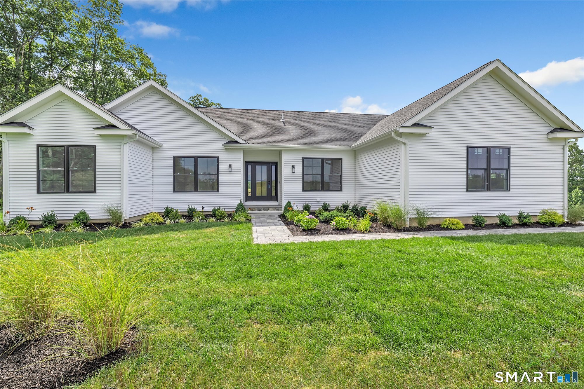 a front view of house with yard and green space