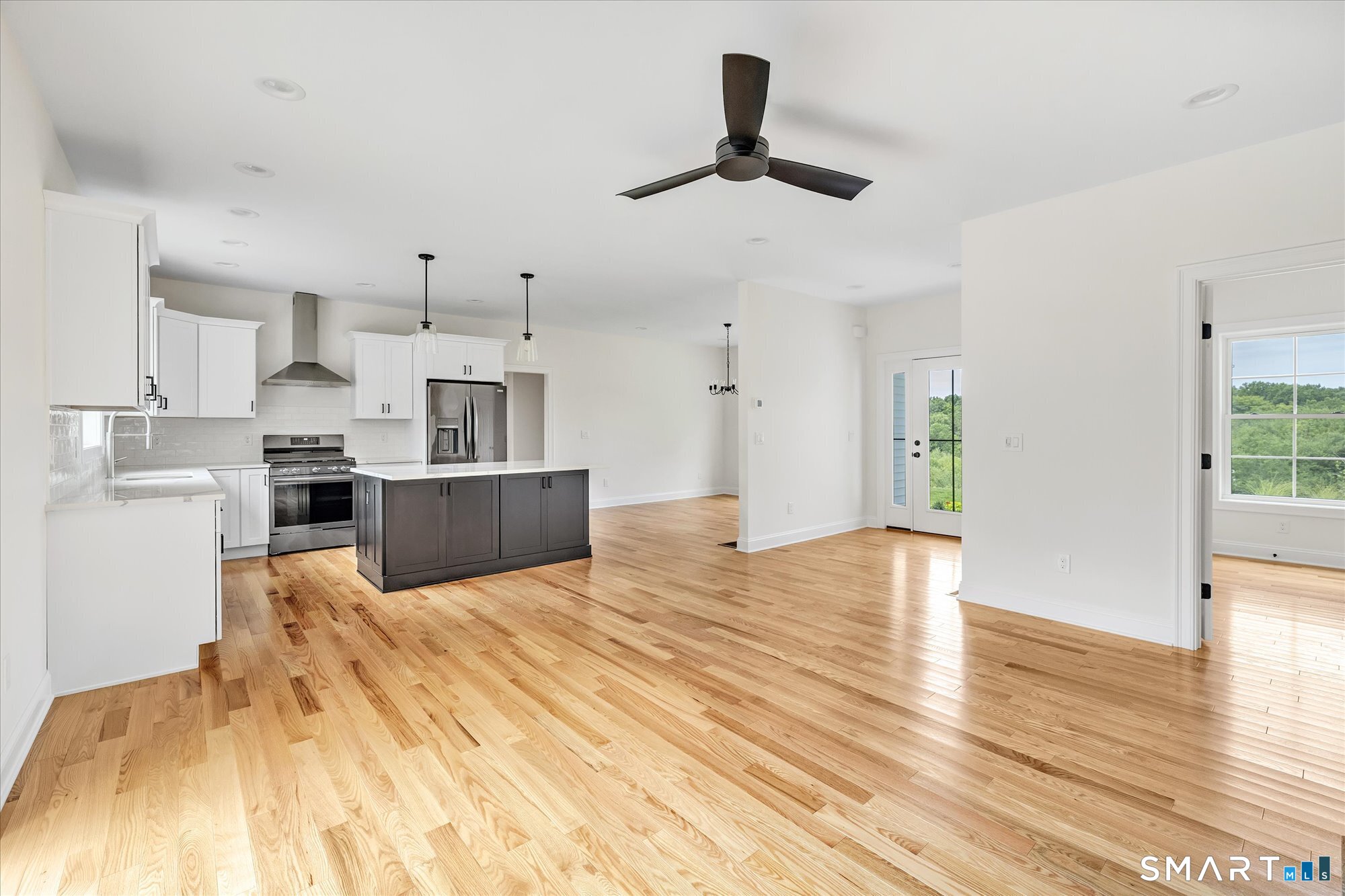 20 Hunting Ridge Road Middlebury, CT 06762 - Photo 13 of 29 a large kitchen with stainless steel appliances kitchen island a stove a refrigerator a sink a microwave and cabinets