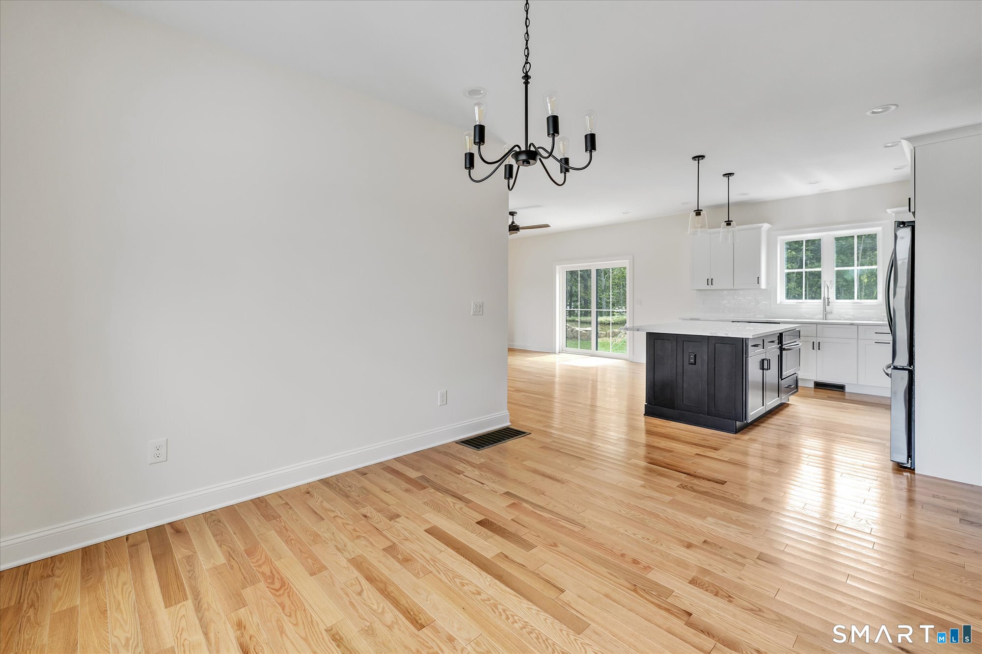 20 Hunting Ridge Road Middlebury, CT 06762 - Photo 14 of 29 a view of a big room with wooden floor and a kitchen