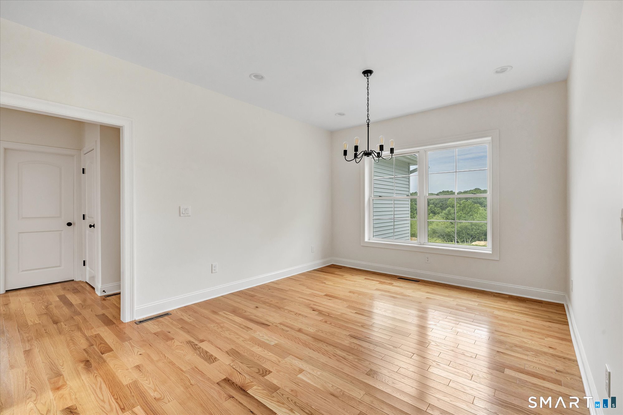 20 Hunting Ridge Road Middlebury, CT 06762 - Photo 17 of 29 a view of empty room with wooden floor ceiling fan and window