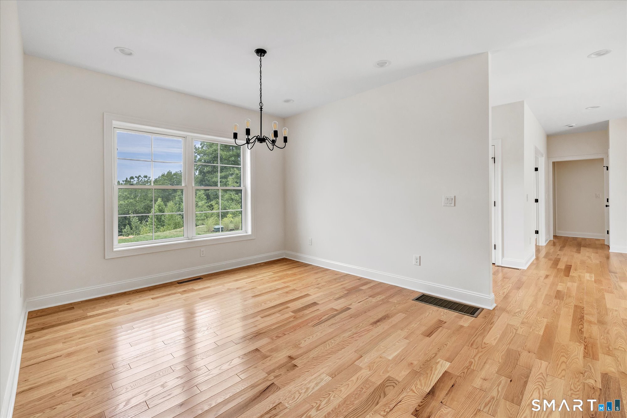20 Hunting Ridge Road Middlebury, CT 06762 - Photo 18 of 29 a view of an empty room with wooden floor fridge and a window