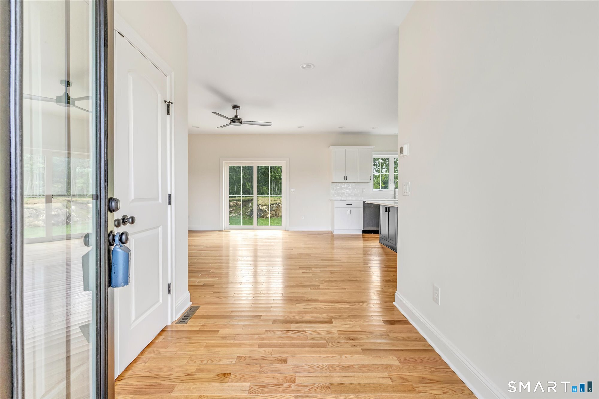20 Hunting Ridge Road Middlebury, CT 06762 - Photo 2 of 29 a view of an empty room with wooden floor and a window