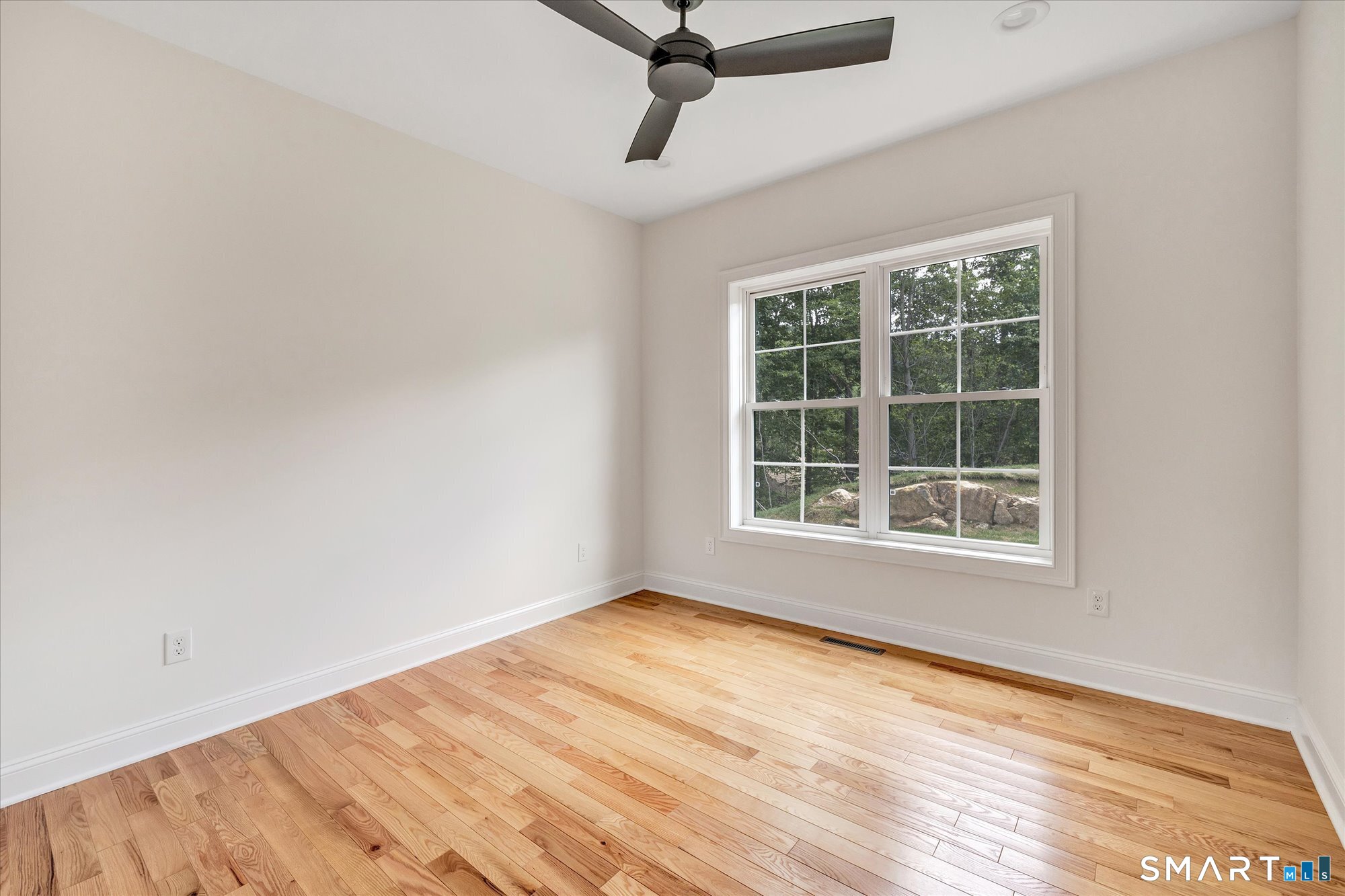20 Hunting Ridge Road Middlebury, CT 06762 - Photo 23 of 29 a view of an empty room with wooden floor and a window