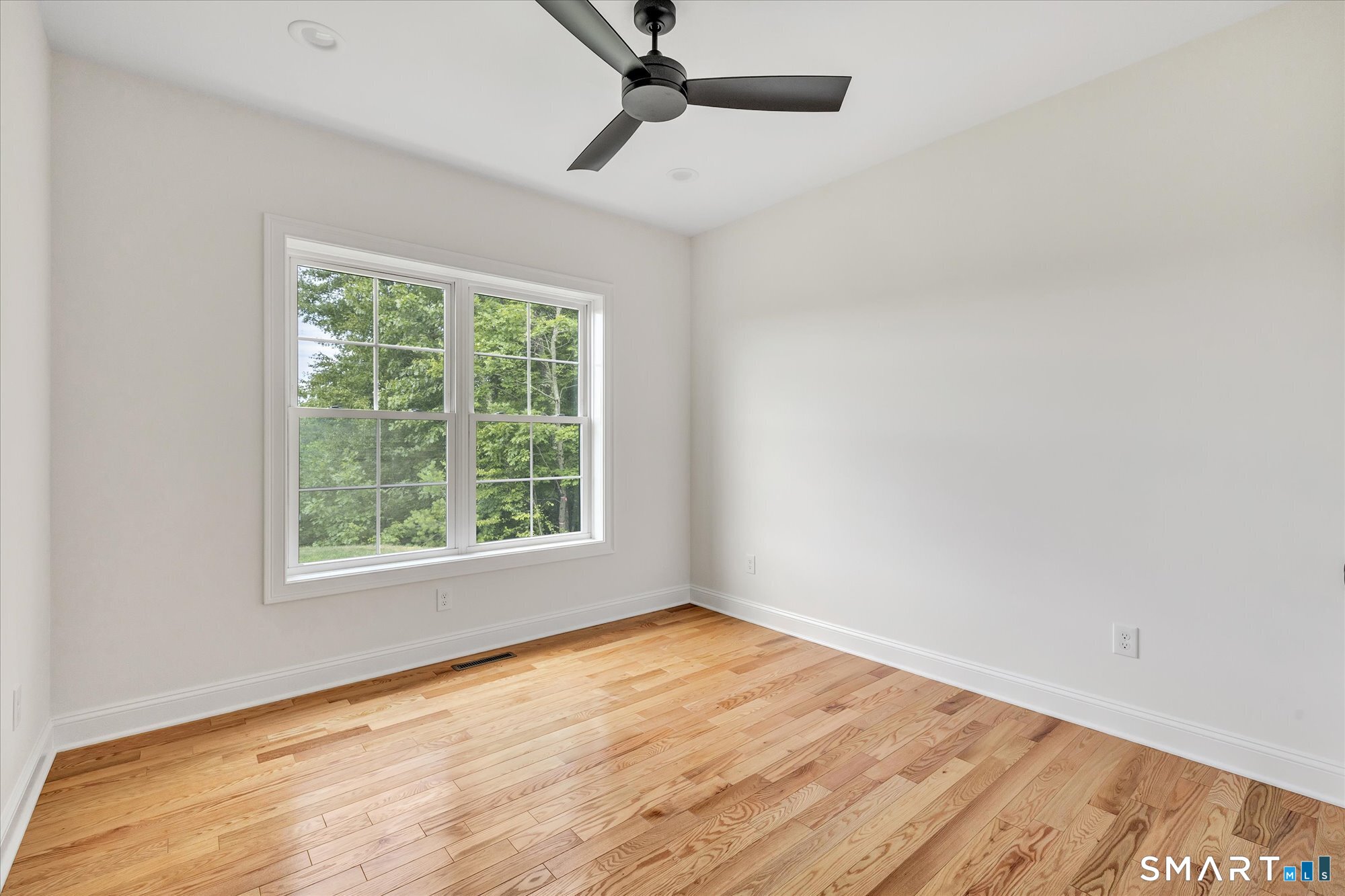 20 Hunting Ridge Road Middlebury, CT 06762 - Photo 25 of 29 a view of an empty room with wooden floor and a window