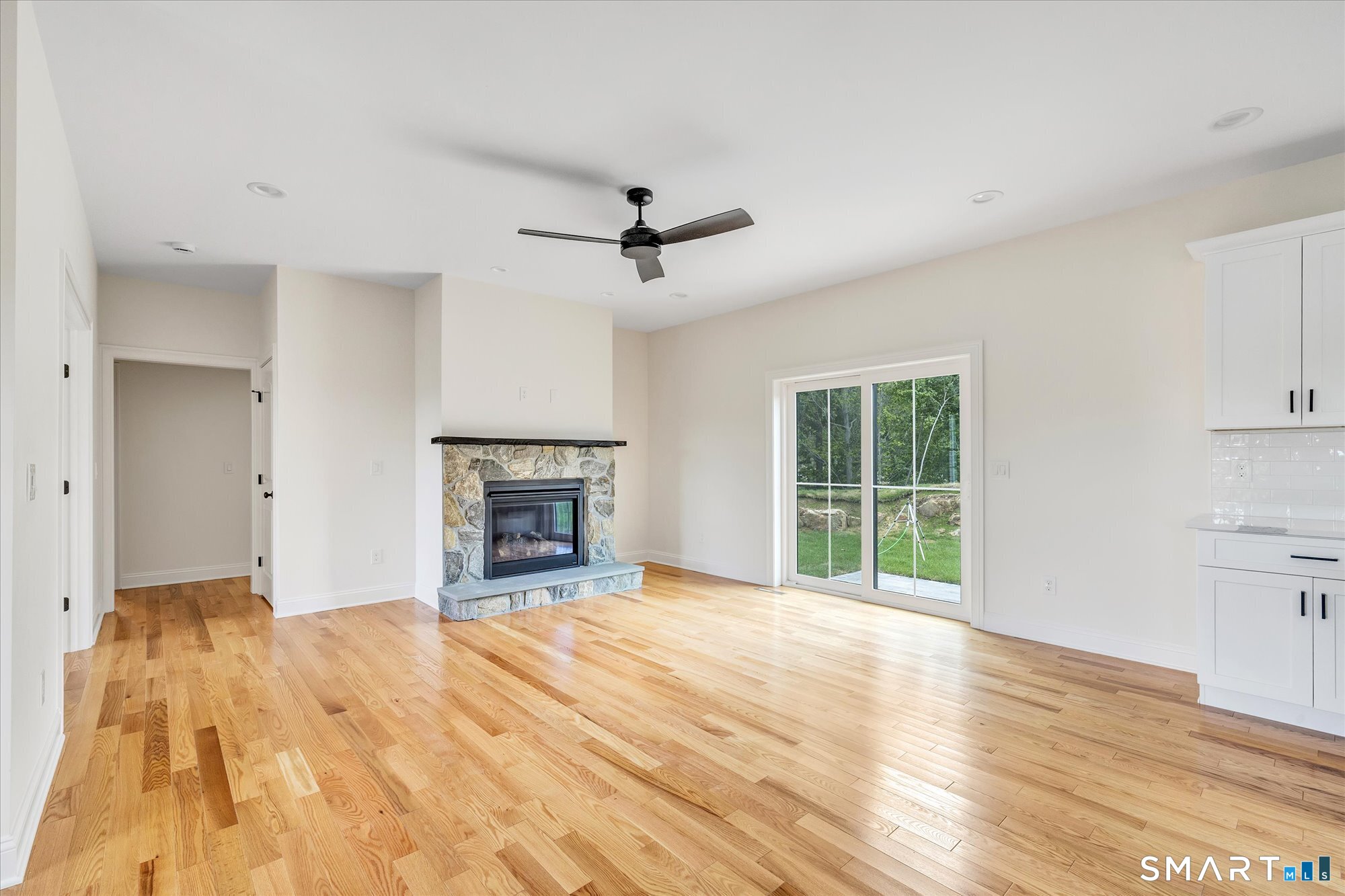 20 Hunting Ridge Road Middlebury, CT 06762 - Photo 4 of 29 a view of an empty room with a fireplace and a window