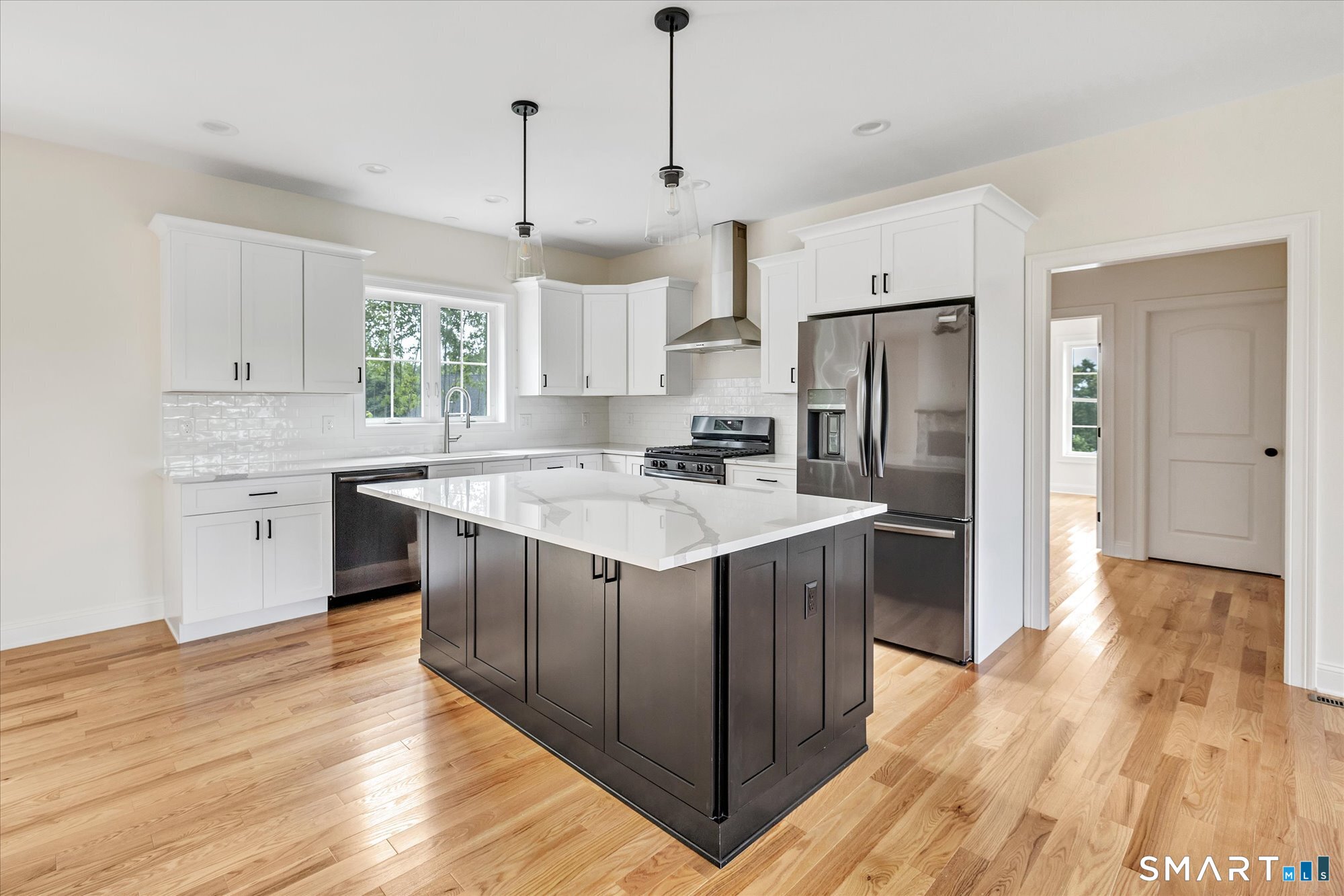 20 Hunting Ridge Road Middlebury, CT 06762 - Photo 7 of 29 a kitchen with kitchen island sink refrigerator and cabinets