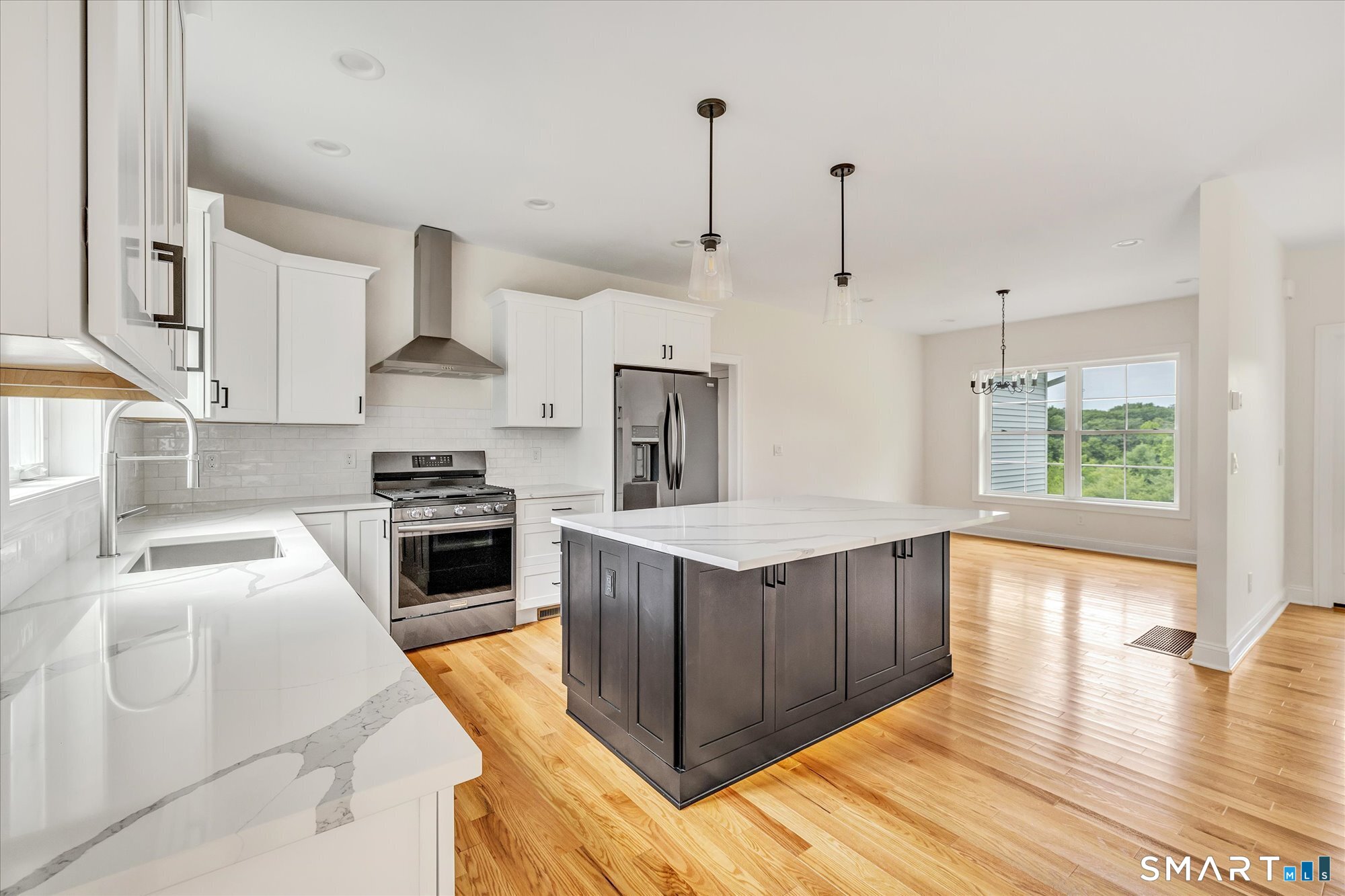 20 Hunting Ridge Road Middlebury, CT 06762 - Photo 10 of 29 a kitchen with wooden cabinets and white appliances