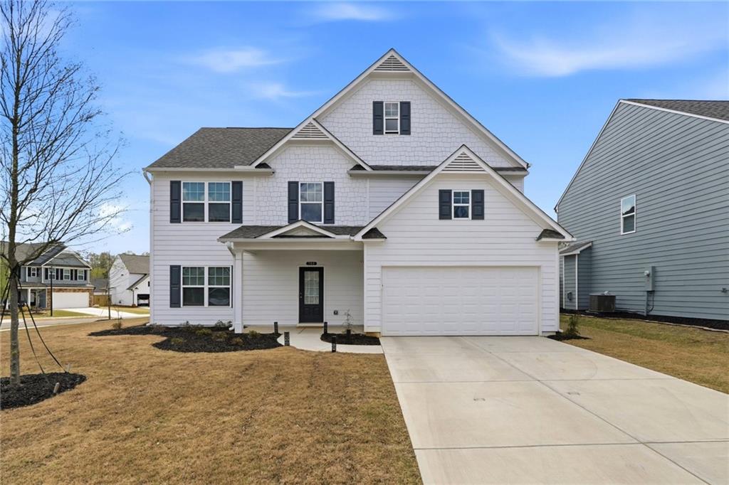 760 Oakmont Trace Canton, GA 30114 - Photo 1 of 25 a front view of a house with a yard