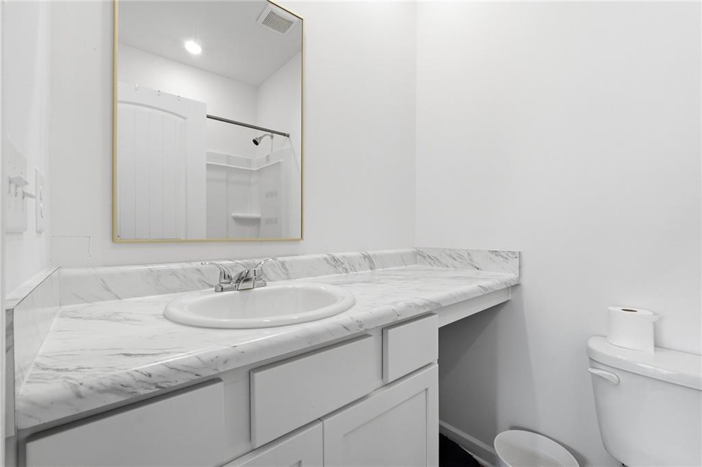 760 Oakmont Trace Canton, GA 30114 - Photo 17 of 25 a bathroom with a granite countertop sink and a mirror