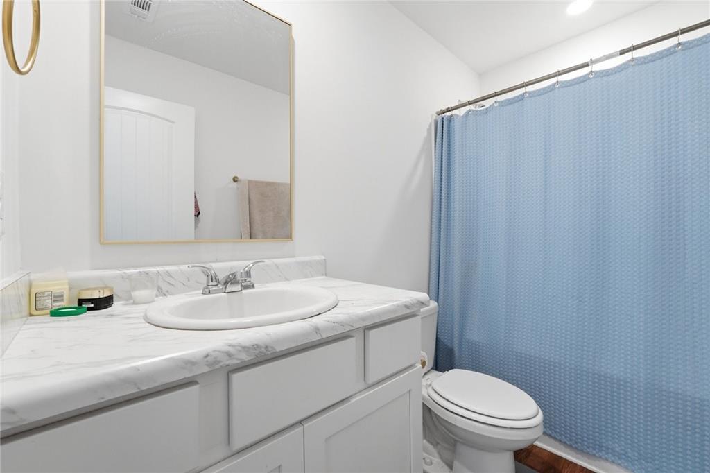 760 Oakmont Trace Canton, GA 30114 - Photo 21 of 25 a bathroom with a sink a toilet and mirror
