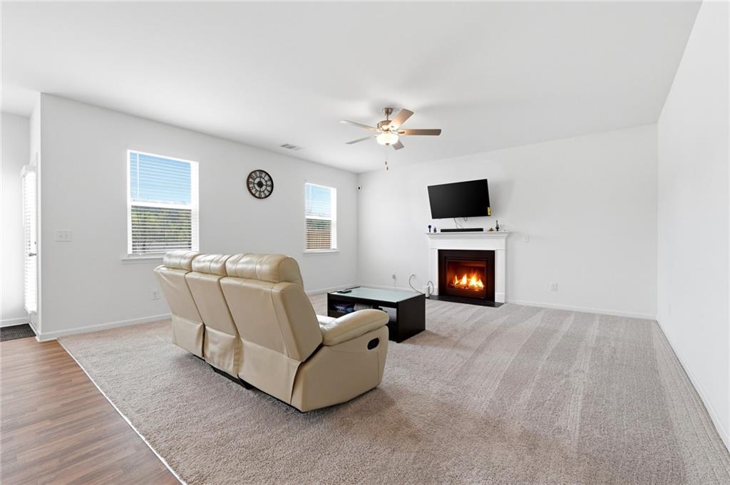 760 Oakmont Trace Canton, GA 30114 - Photo 5 of 25 a living room with furniture and a fireplace