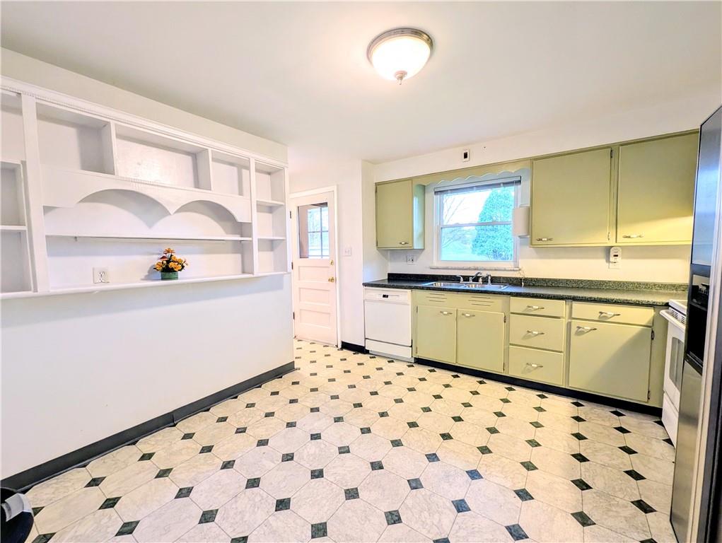 362 Mercer Road Harmony, PA 16037 - Photo 7 of 34 a kitchen with a sink a stove a window and cabinets