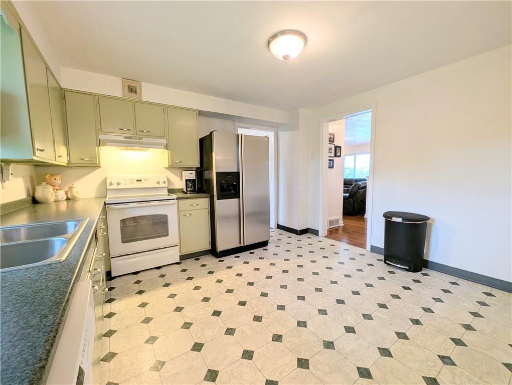 362 Mercer Road Harmony, PA 16037 - Photo 9 of 34 a kitchen with granite countertop a refrigerator stove and sink