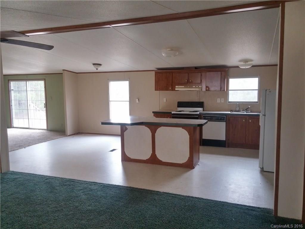 1818 State Rd S-28-55 Lugoff, SC 29078 - Photo 3 of 12 a kitchen with stainless steel appliances granite countertop a stove a sink and a refrigerator