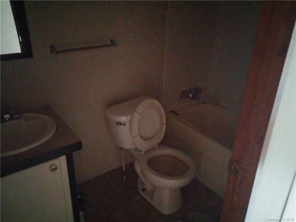 1818 State Rd S-28-55 Lugoff, SC 29078 - Photo 10 of 12 a bathroom with a toilet and a sink