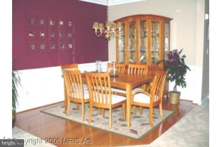 a view of a dining room with furniture and a chandelier