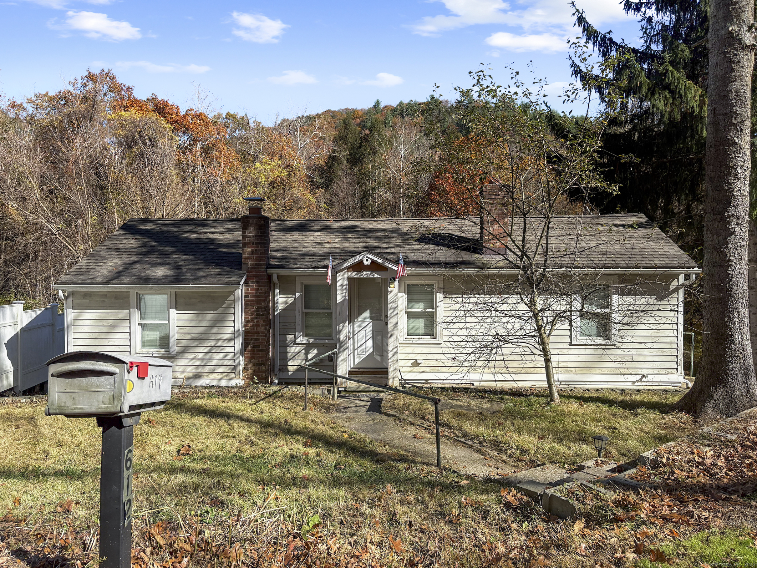 a view of a wooden house with a yard