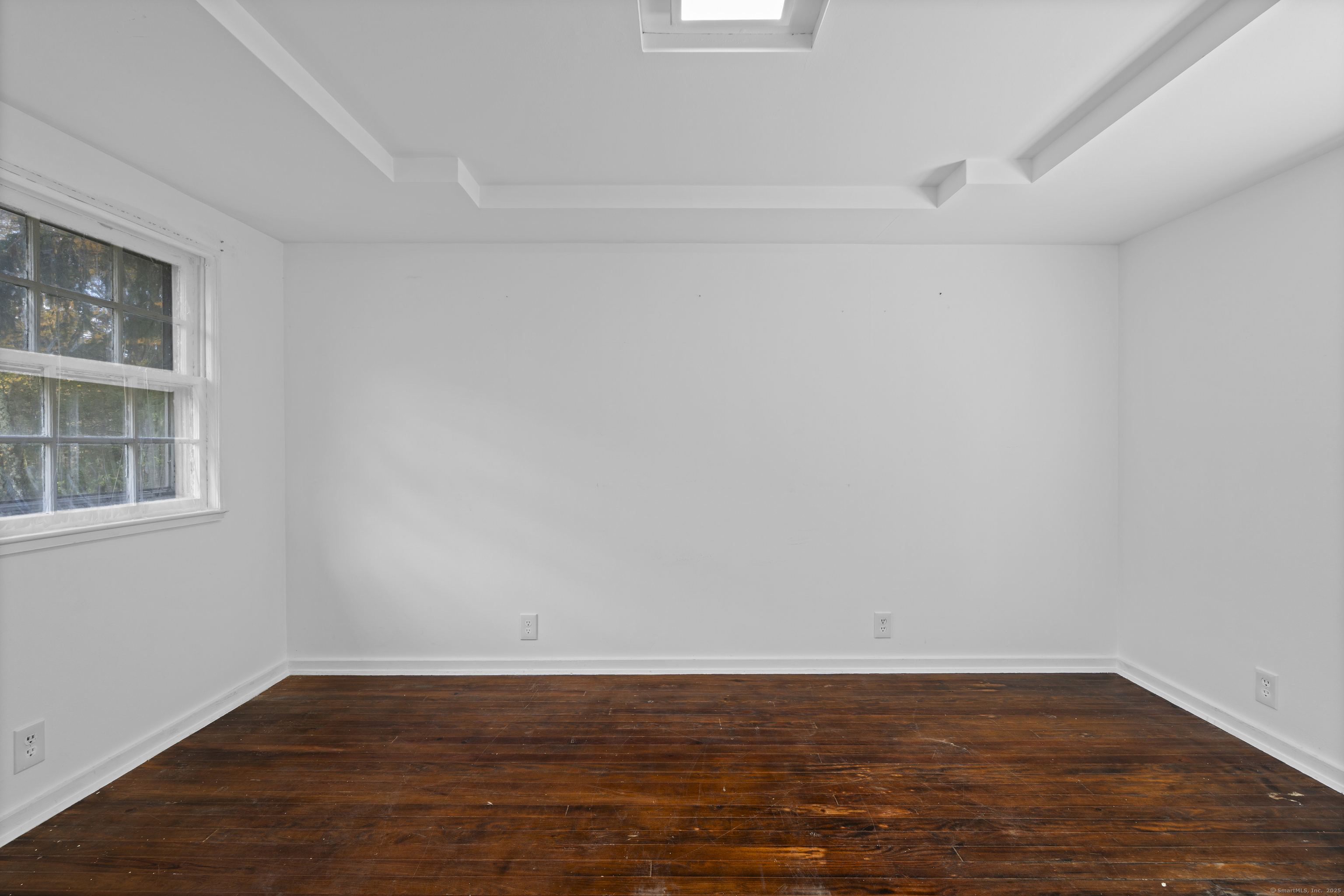 612 Kent Road New Milford, CT 06755 - Photo 15 of 35 a view of an empty room with wooden floor and a window