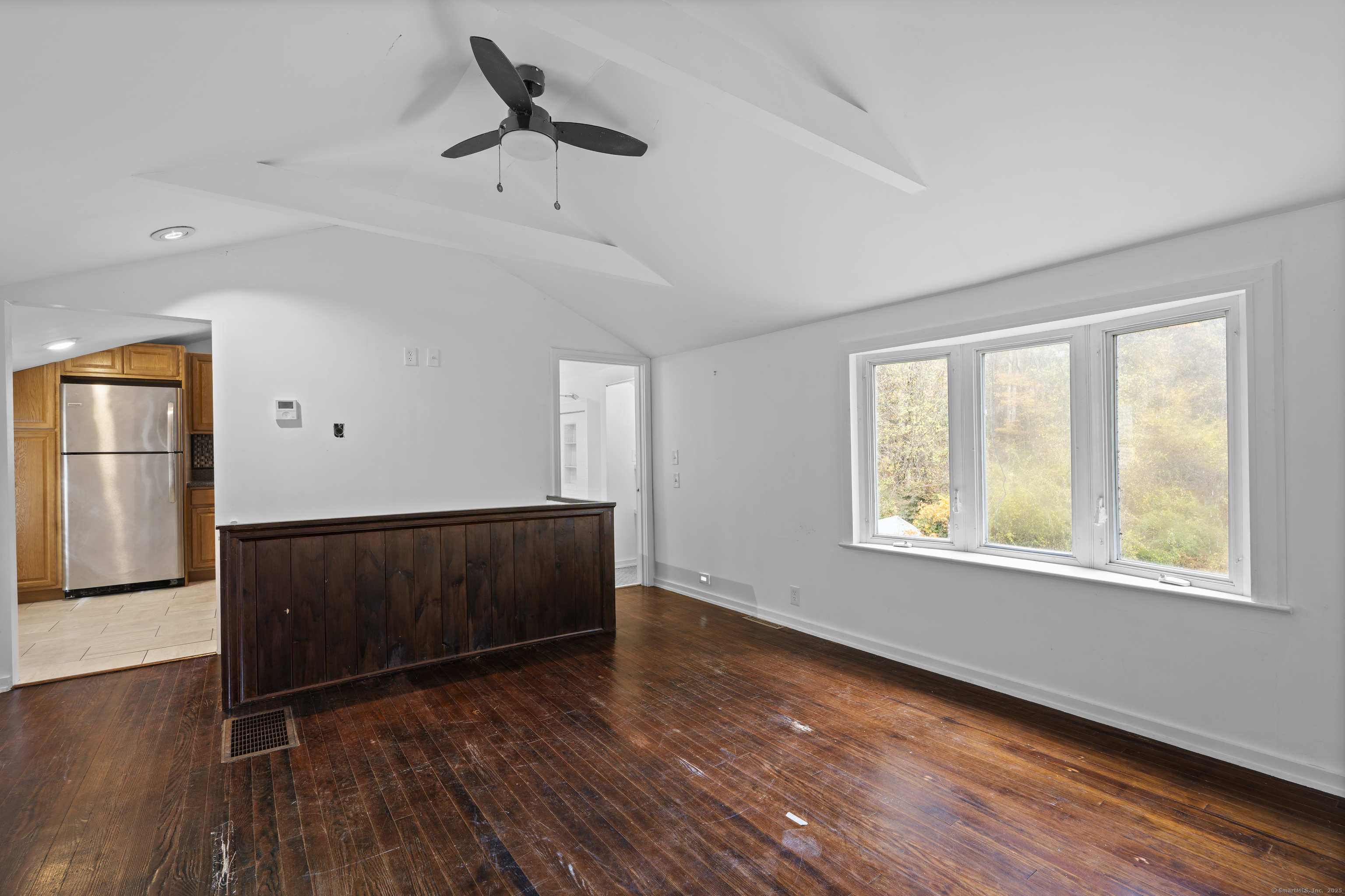 612 Kent Road New Milford, CT 06755 - Photo 19 of 35 a view of an empty room with wooden floor and a window