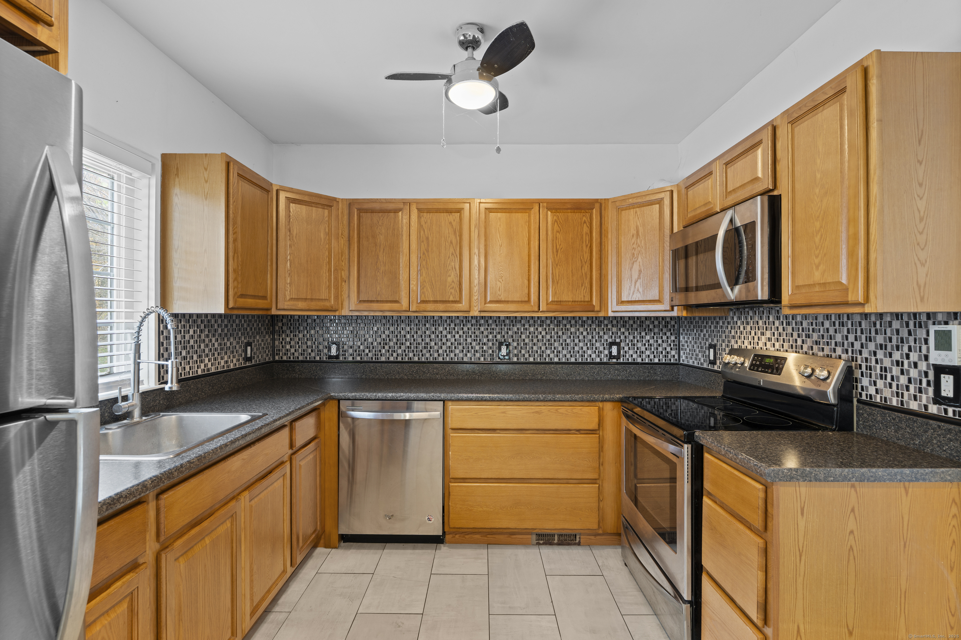 612 Kent Road New Milford, CT 06755 - Photo 2 of 35 a kitchen with stainless steel appliances granite countertop a sink stove and refrigerator