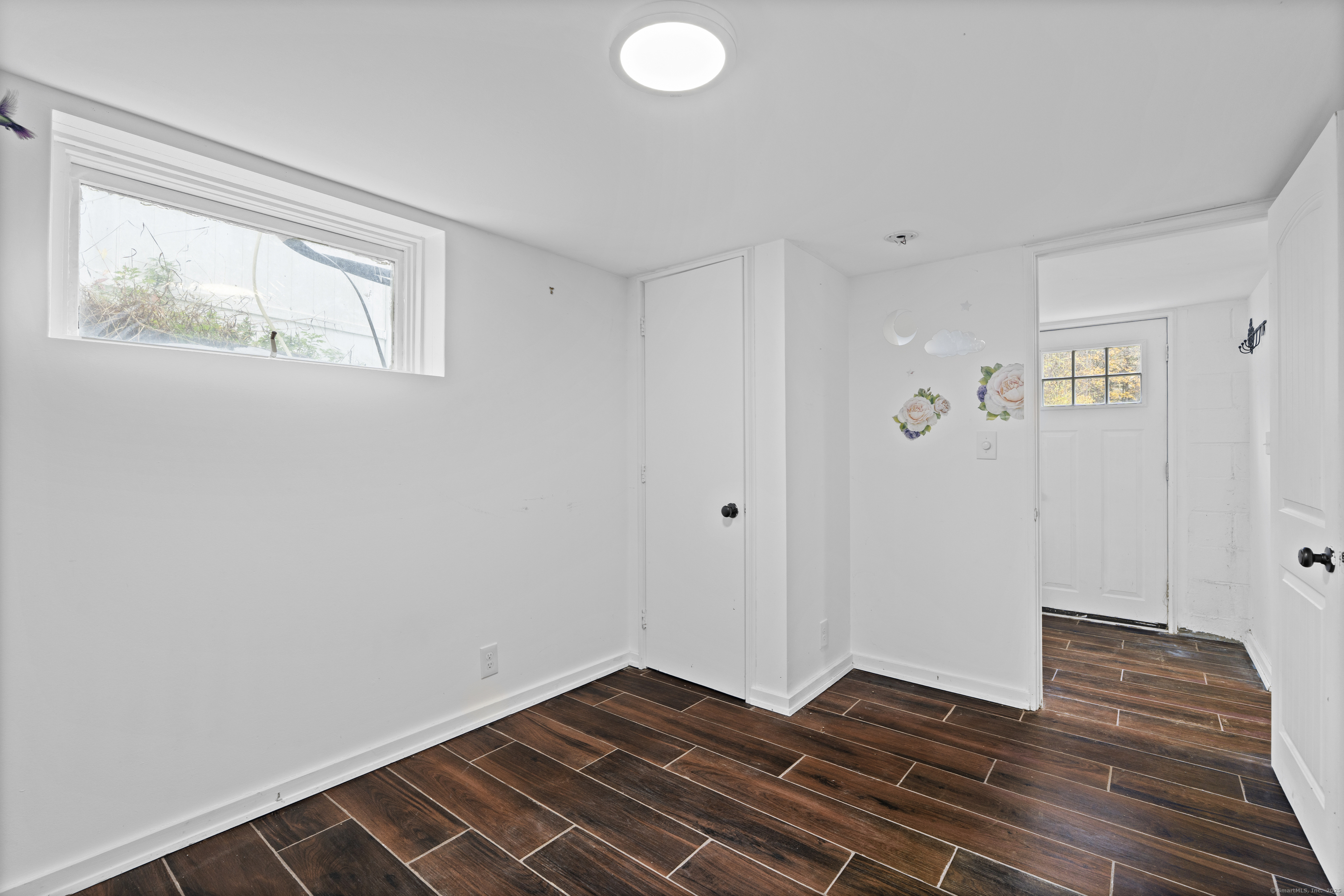612 Kent Road New Milford, CT 06755 - Photo 21 of 35 a view of an empty room with wooden floor and a window