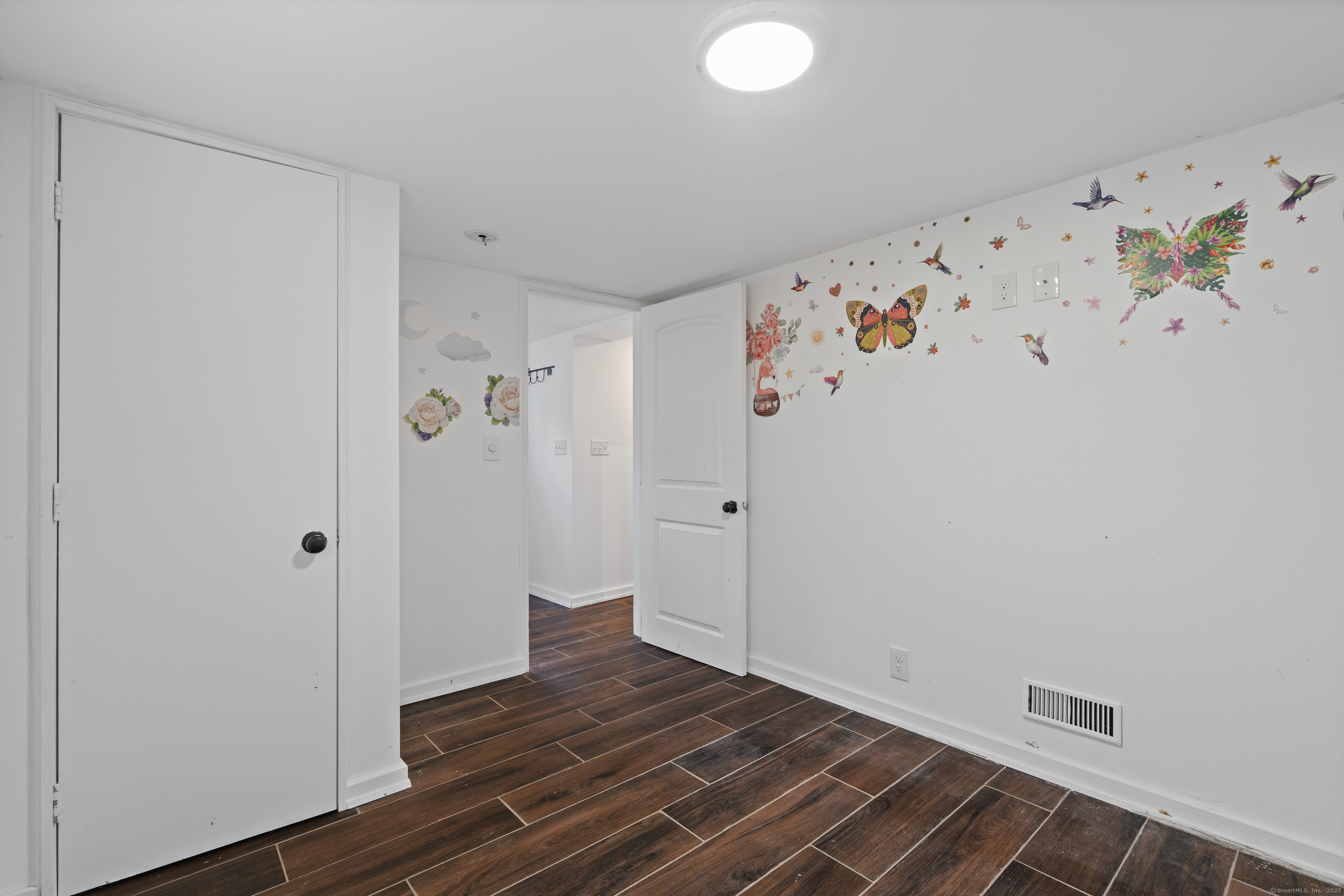 612 Kent Road New Milford, CT 06755 - Photo 22 of 35 a view of a room with wooden floor and cabinet