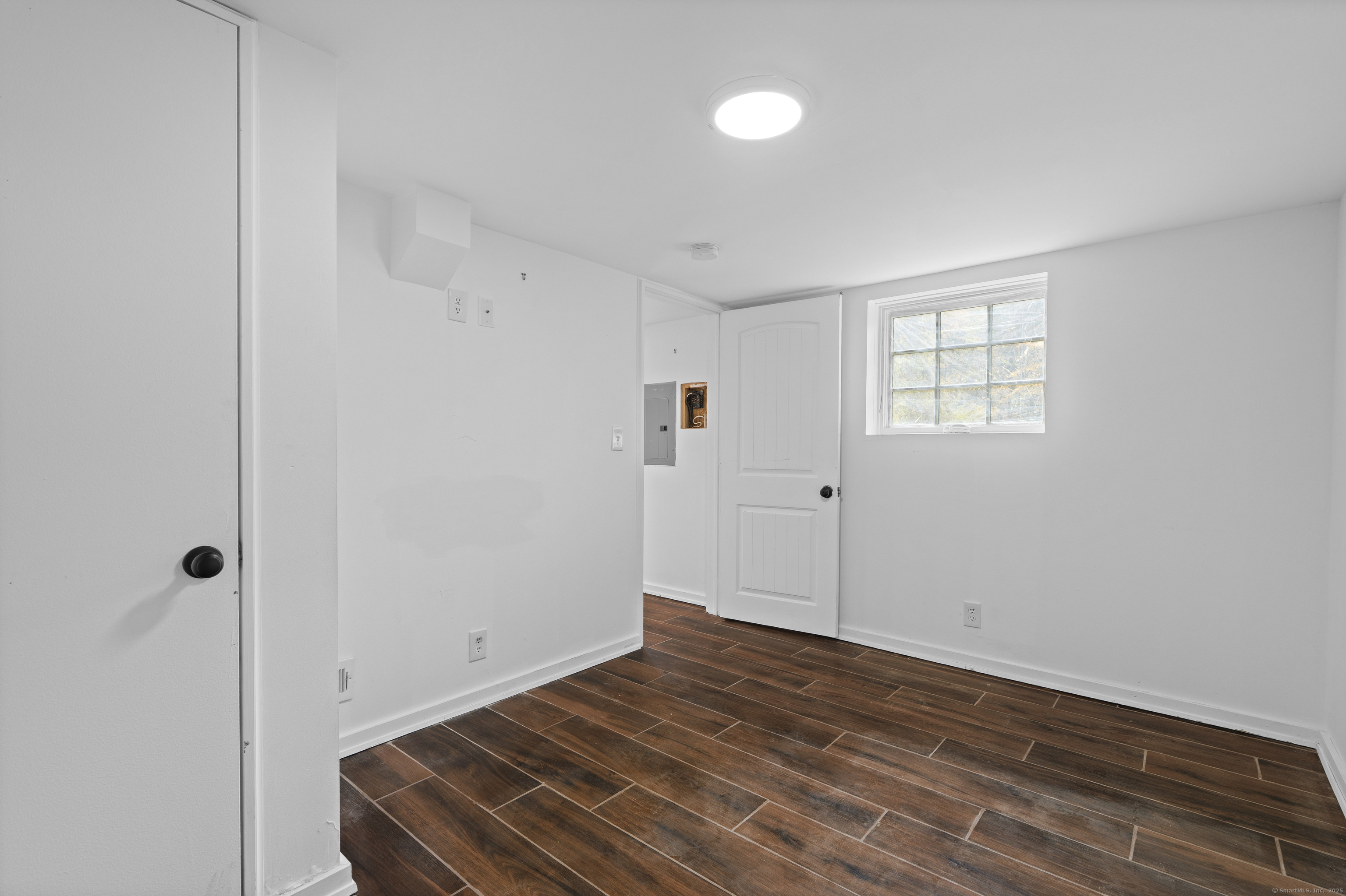 612 Kent Road New Milford, CT 06755 - Photo 30 of 35 a view of an empty room with wooden floor and a window