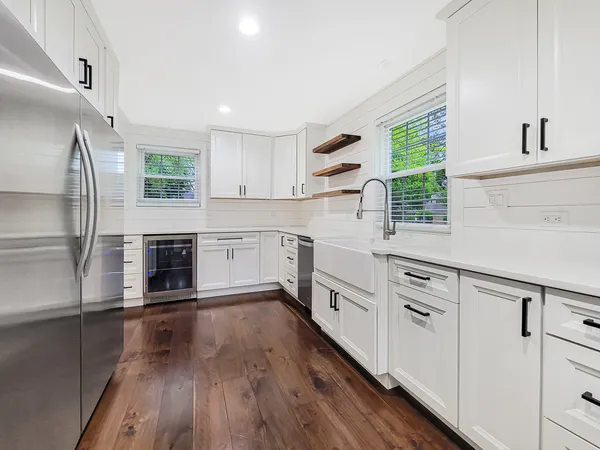 a kitchen with stainless steel appliances a stove sink and refrigerator