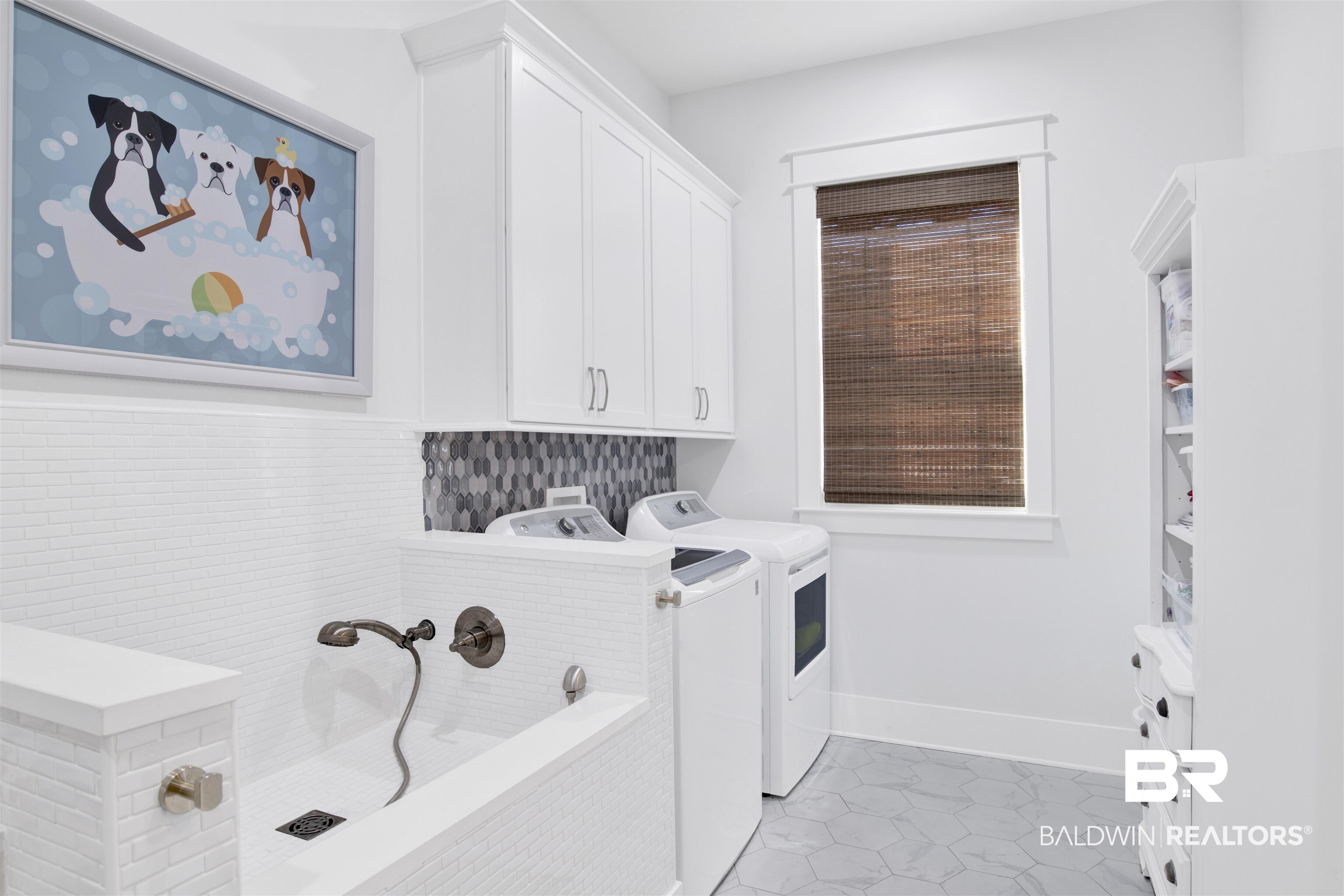 32937 River Road Orange Beach, AL 36561 - Photo 22 of 42 Clothes washing area with cabinets, light tile patterned floors, and washing machine and dryer
