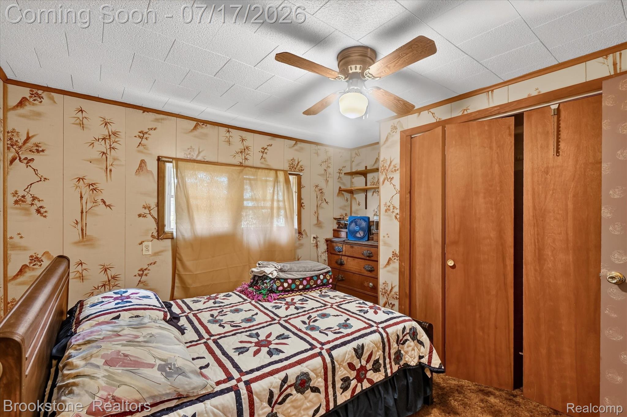 22025 Lakefield Road Merrill, MI 48637 - Photo 25 of 47 Bedroom featuring a ceiling fan with integrated lighting, two windows, and wood-finish paneling